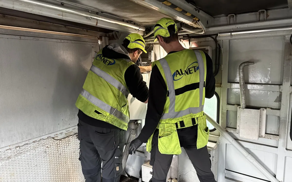 Alnet technicians at work in a vehicle equipment room