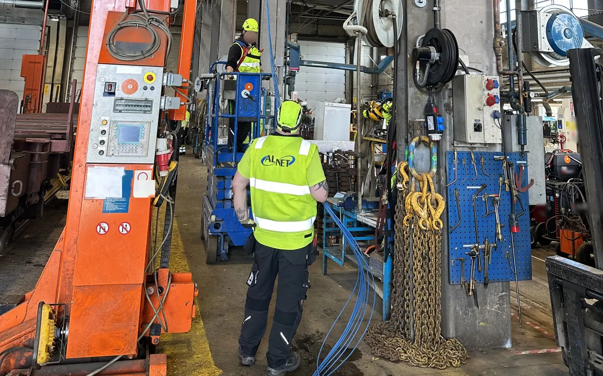 Alnet technicians doing cabling work in a rolling stock depot